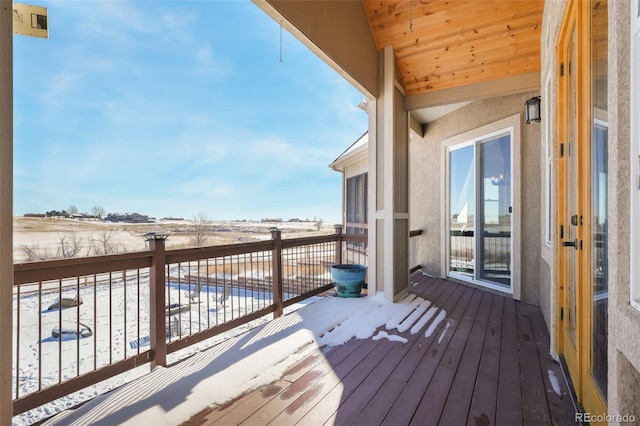 view of snow covered back of property