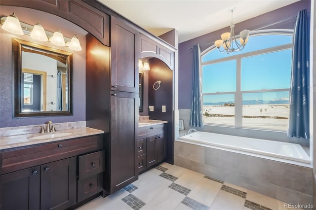 bathroom with tile patterned flooring, vanity, a chandelier, and a relaxing tiled tub