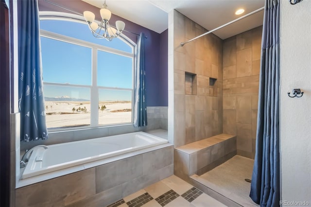 bathroom with tile patterned flooring, shower with separate bathtub, and a notable chandelier