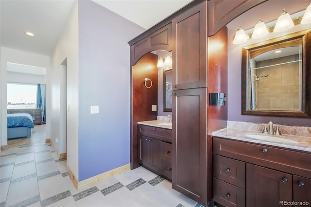 bathroom featuring tile patterned floors, a shower, and vanity