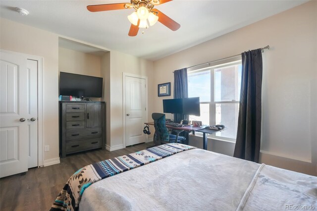 bedroom with ceiling fan and dark wood-type flooring