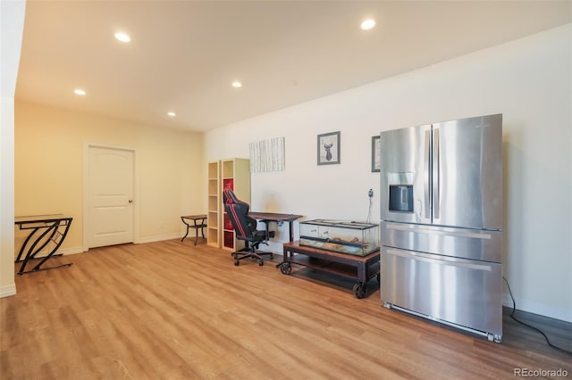 interior space featuring stainless steel fridge and light hardwood / wood-style flooring