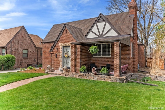 2995 Albion St, Denver, CO 80207 - english style home with roof with shingles, brick siding, a front lawn, and a chimney