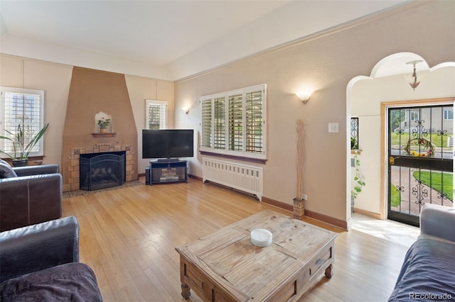 2995 Albion St, Denver, CO 80207 - living area featuring a wealth of natural light, radiator heating unit, and wood-type flooring