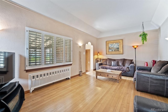 2995 Albion St, Denver, CO 80207 - living area with hardwood / wood-style flooring, radiator, arched walkways, and a textured wall