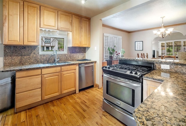 2995 Albion St, Denver, CO 80207 - kitchen featuring a sink, backsplash, light brown cabinetry, a notable chandelier, and appliances with stainless steel finishes