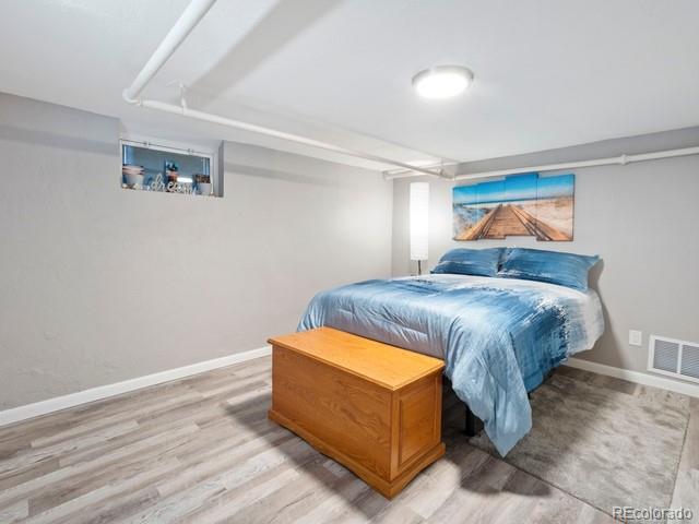 2995 Albion St, Denver, CO 80207 - bedroom with baseboards, visible vents, and wood finished floors