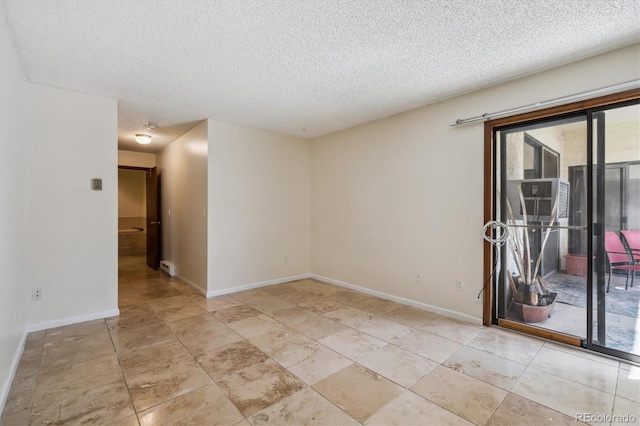 13950 E Oxford Pl Unit B105, Aurora, CO 80014 - empty room featuring a textured ceiling and baseboards