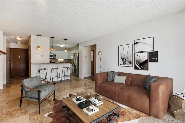 13950 E Oxford Pl Unit B105, Aurora, CO 80014 - living area featuring a textured ceiling