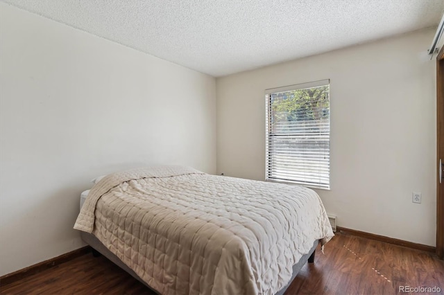 13950 E Oxford Pl Unit B105, Aurora, CO 80014 - bedroom with baseboards, wood finished floors, and a textured ceiling