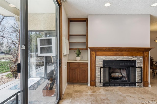 13950 E Oxford Pl Unit B105, Aurora, CO 80014 - unfurnished living room with a tile fireplace and a textured ceiling