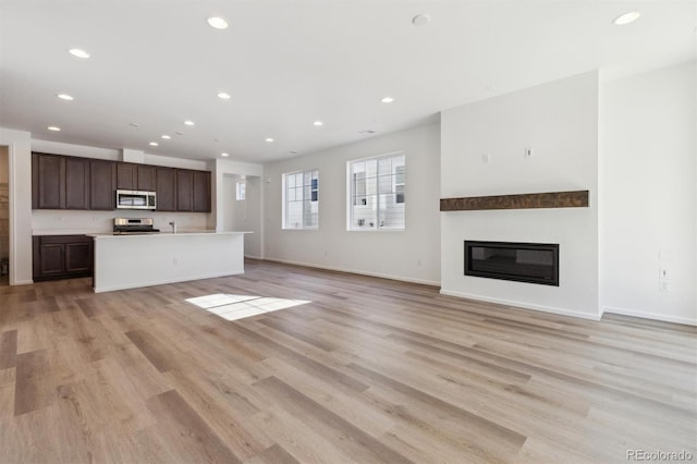 unfurnished living room with light wood-type flooring