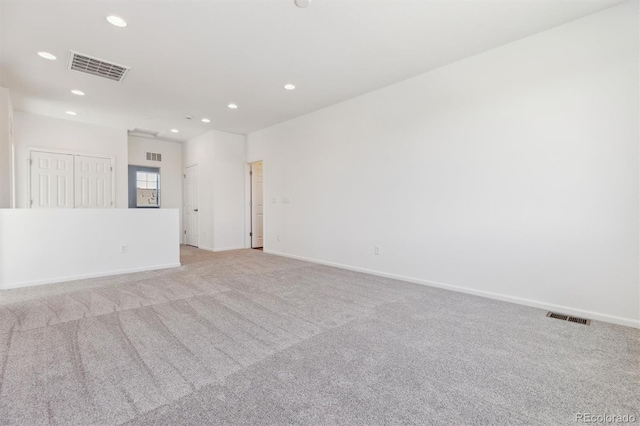 unfurnished room featuring light colored carpet