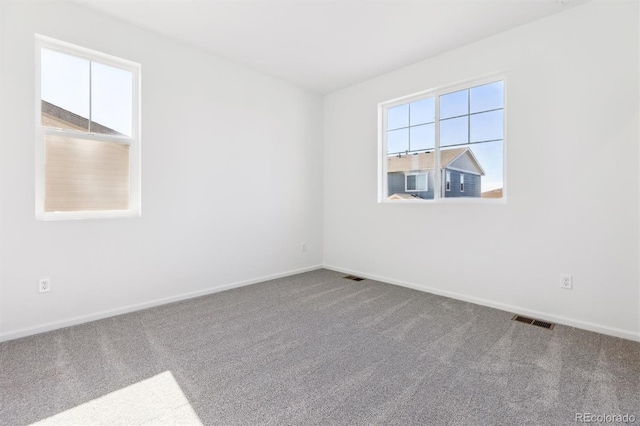 unfurnished room featuring carpet