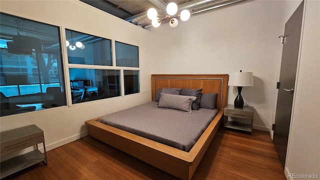 bedroom featuring a chandelier and dark hardwood / wood-style floors