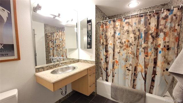 full bathroom featuring tile patterned flooring, shower / bath combination with curtain, toilet, and sink