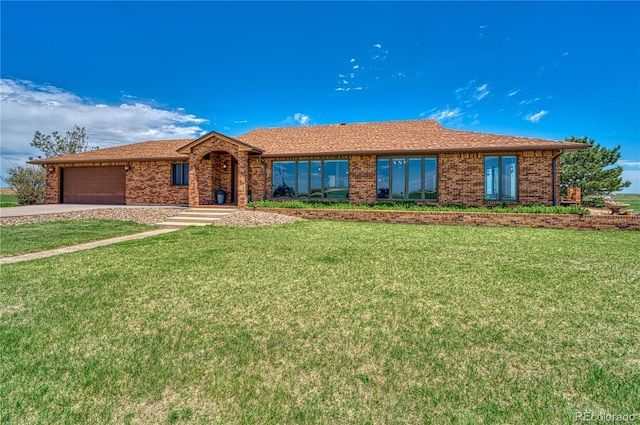 ranch-style house featuring a front yard and a garage