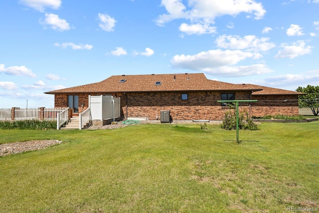 back of property featuring a lawn and cooling unit