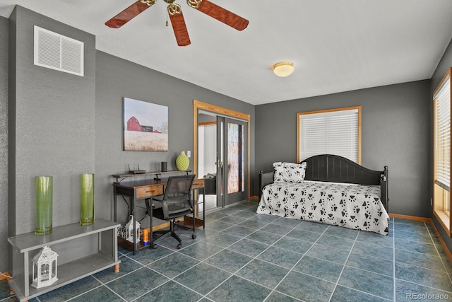 bedroom with ceiling fan and dark tile patterned flooring