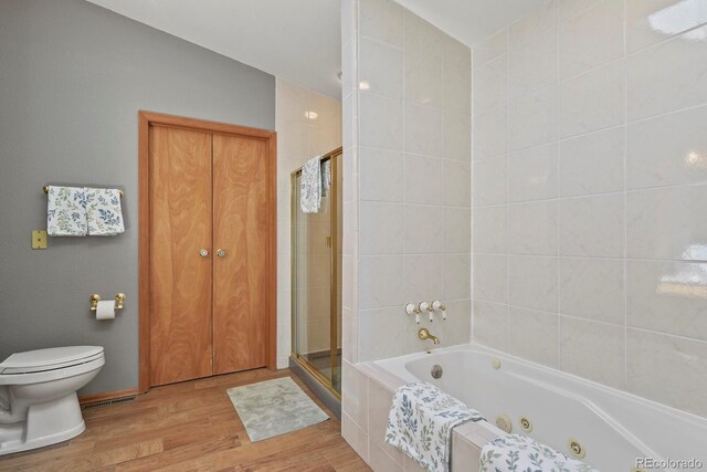 bathroom with hardwood / wood-style flooring, independent shower and bath, and toilet