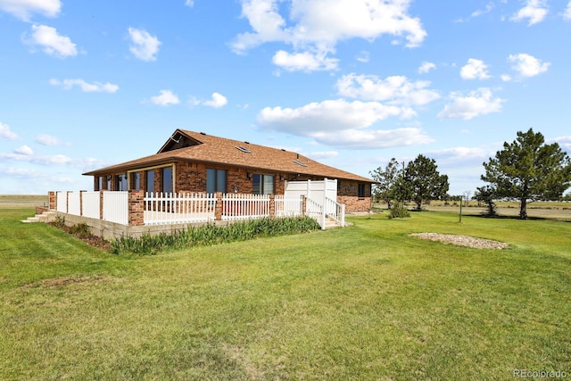 rear view of house with a yard