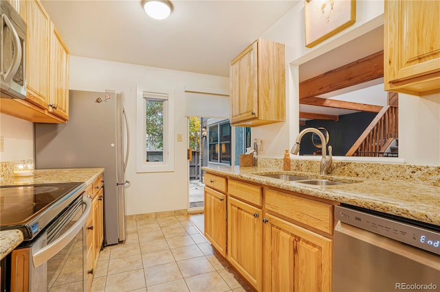 1152 S Yosemite Way Unit 29, Denver, CO 80247 - kitchen with stainless steel appliances, light stone counters, and light tile patterned floors