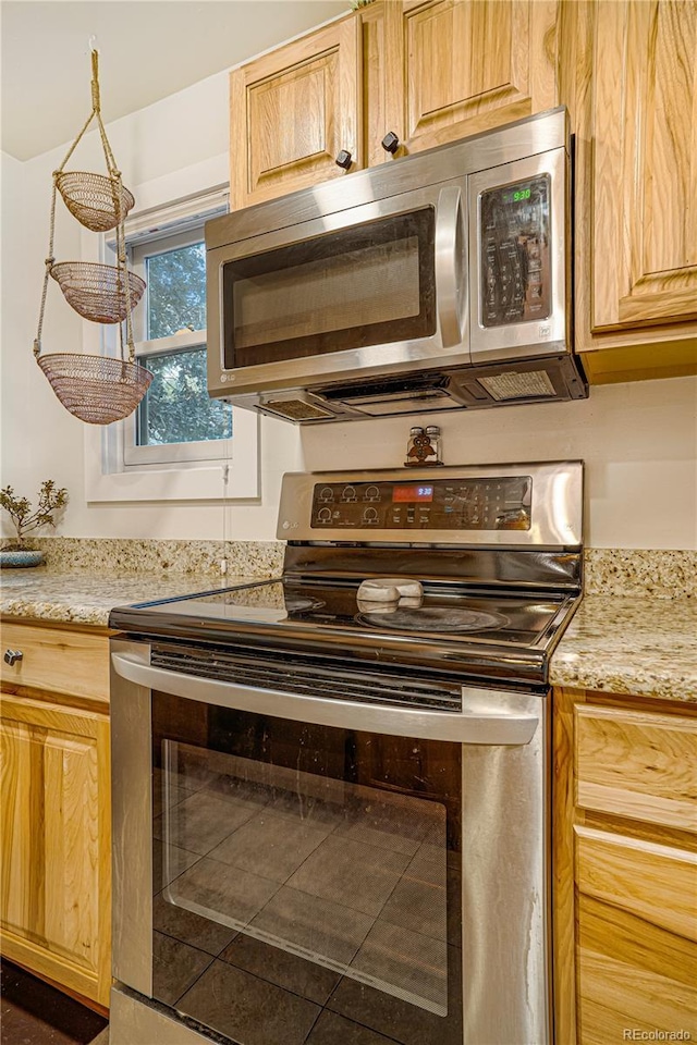 1152 S Yosemite Way Unit 29, Denver, CO 80247 - kitchen with stainless steel appliances and light stone counters