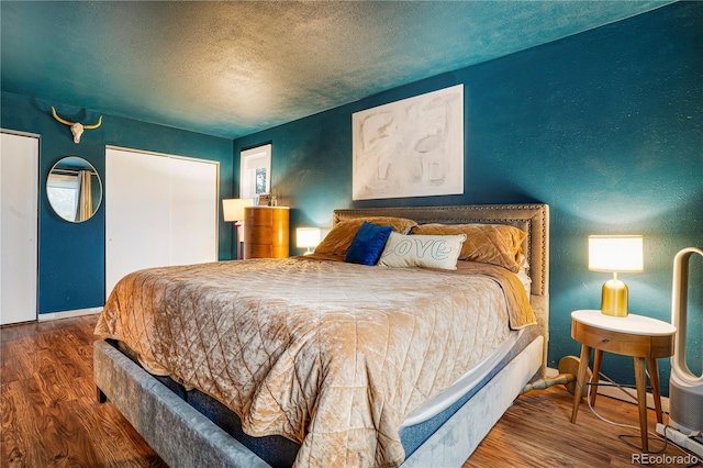 1152 S Yosemite Way Unit 29, Denver, CO 80247 - bedroom featuring wood finished floors, a textured ceiling, and a textured wall
