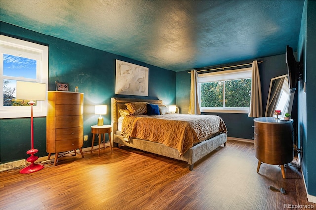 1152 S Yosemite Way Unit 29, Denver, CO 80247 - bedroom featuring a textured ceiling and wood finished floors
