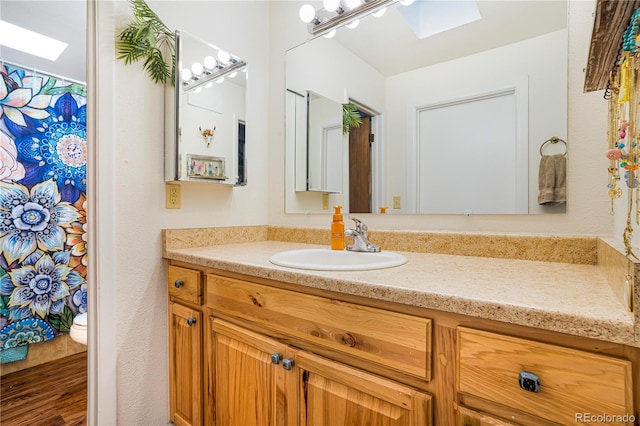 1152 S Yosemite Way Unit 29, Denver, CO 80247 - full bathroom with a skylight, vanity, and wood finished floors