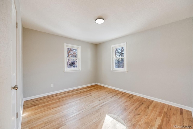 spare room with light hardwood / wood-style floors