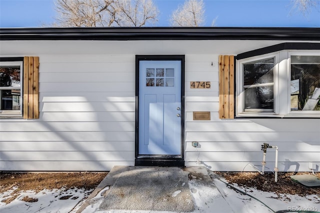 view of snow covered property entrance