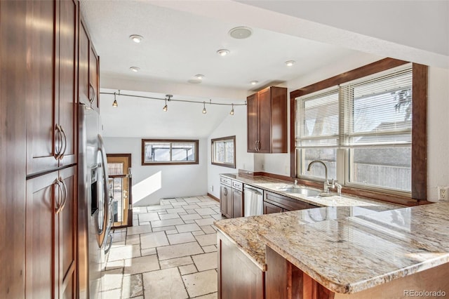 kitchen featuring stainless steel appliances, sink, vaulted ceiling, light stone counters, and kitchen peninsula