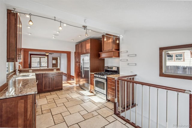 kitchen featuring stainless steel appliances, sink, ceiling fan, premium range hood, and light stone countertops