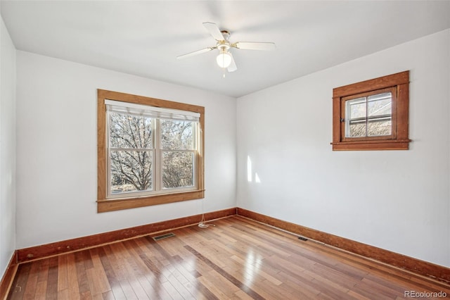 unfurnished room with wood-type flooring and ceiling fan