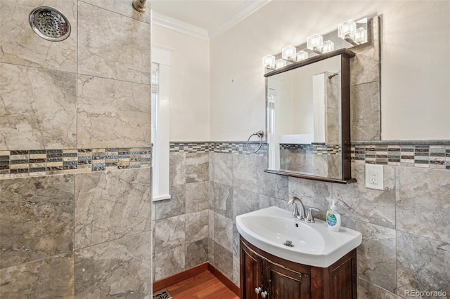 bathroom featuring tile walls, crown molding, and vanity