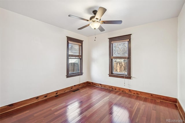 spare room with ceiling fan and hardwood / wood-style flooring