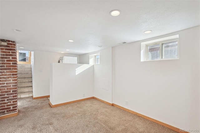 basement featuring light carpet