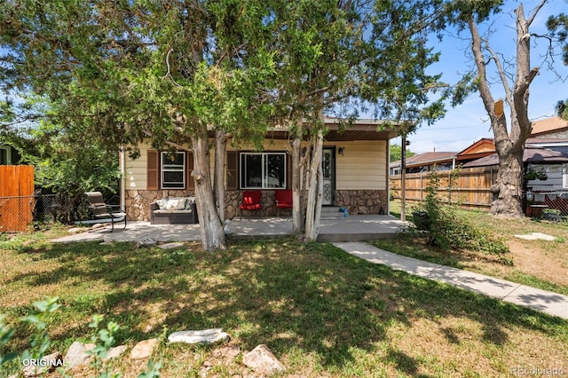 5481 Leyden St, Commerce City, CO 80022 - view of front of home with stone siding and a patio