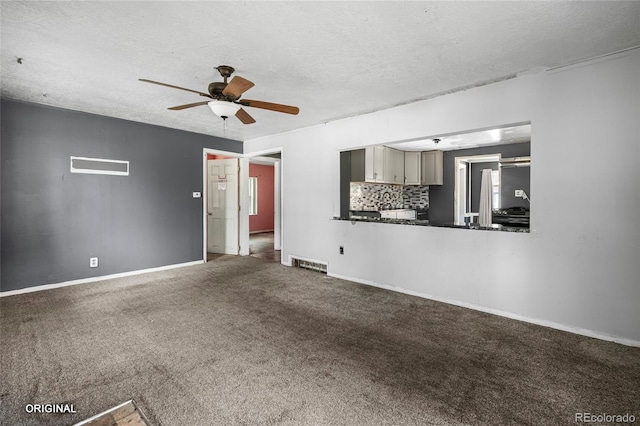 5481 Leyden St, Commerce City, CO 80022 - unfurnished living room featuring ceiling fan, a textured ceiling, and carpet