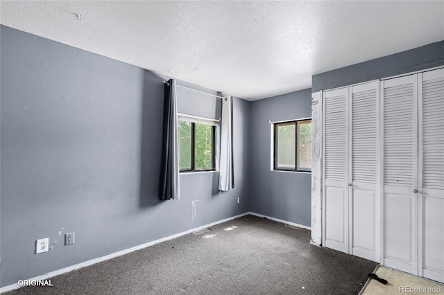 5481 Leyden St, Commerce City, CO 80022 - unfurnished bedroom with a textured ceiling, a closet, and carpet