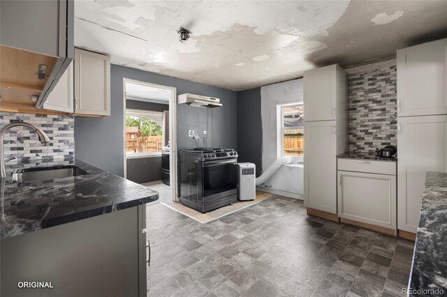 5481 Leyden St, Commerce City, CO 80022 - kitchen with stainless steel gas range, backsplash, and ventilation hood