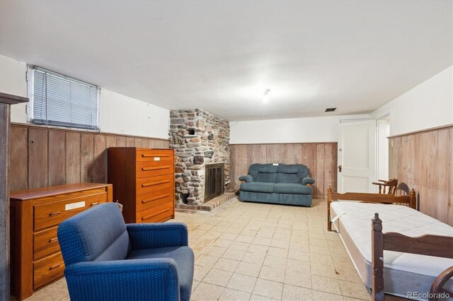 675 Holland St, Lakewood, CO 80215 - living room featuring wooden walls, wainscoting, and a fireplace
