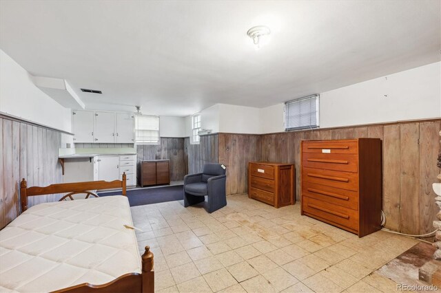 675 Holland St, Lakewood, CO 80215 - bedroom featuring wood walls and wainscoting