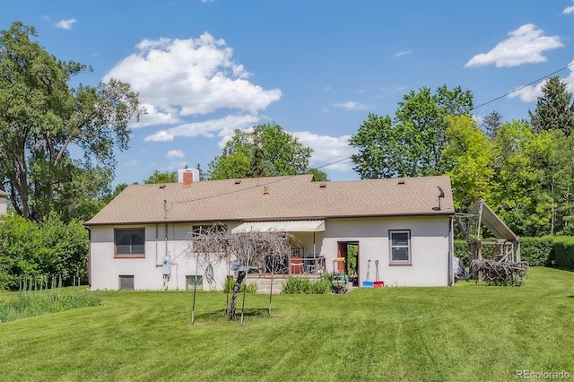 675 Holland St, Lakewood, CO 80215 - rear view of property featuring stucco siding, a yard, a chimney, and a shingled roof