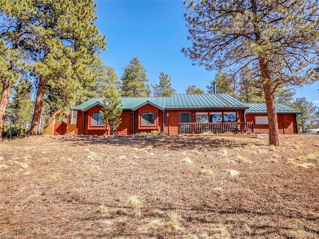 rustic home featuring metal roof and a standing seam roof