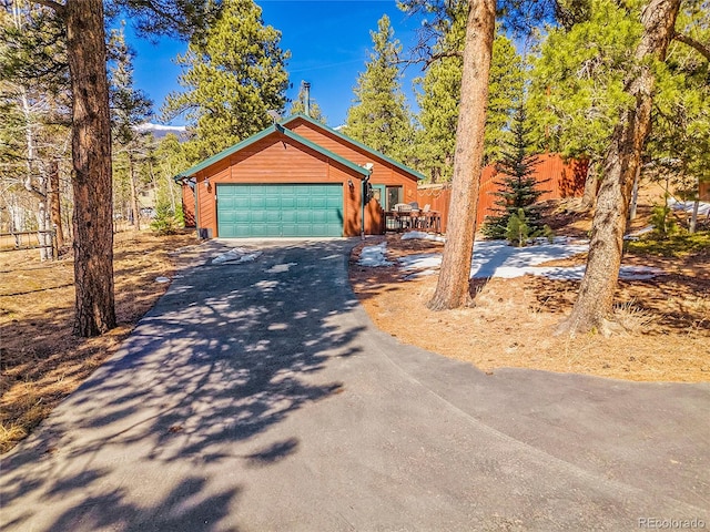 view of front of property featuring aphalt driveway and a garage