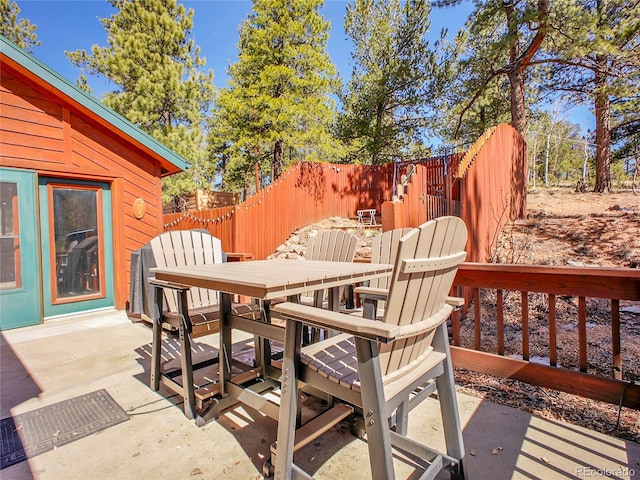 exterior space with outdoor dining space and fence