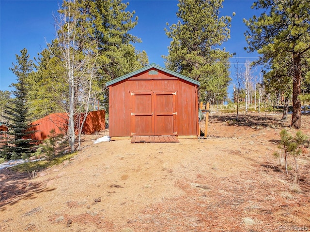 view of shed with fence