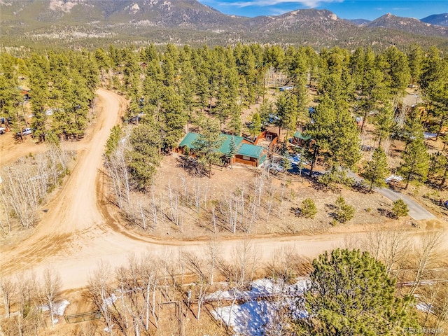 birds eye view of property with a wooded view and a mountain view